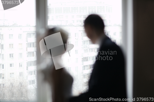 Image of Bridal pair looking out the window