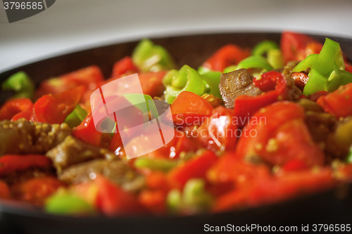 Image of Served dish with meat, tomatoes and pepper