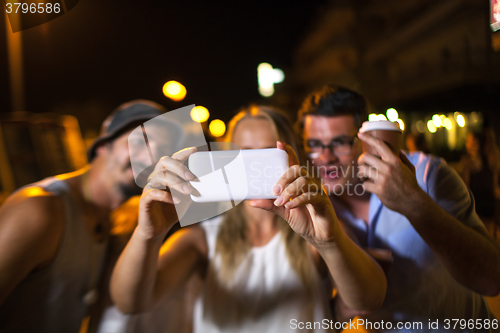 Image of Friends selfie at night