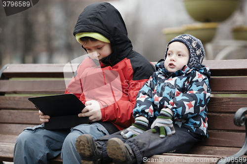 Image of Brothers with tablet computer