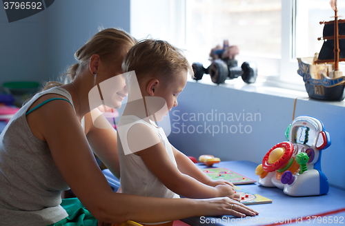 Image of Mother playing learning game with son