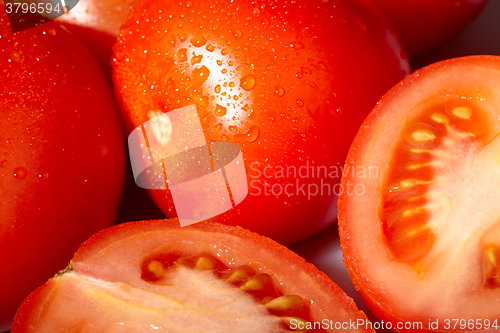 Image of Fresh red tomatoes with water drops.