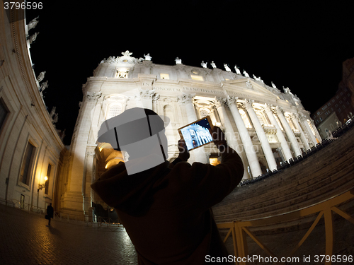 Image of Tourist with pad shooting St. Peters Basilica in Vatican City