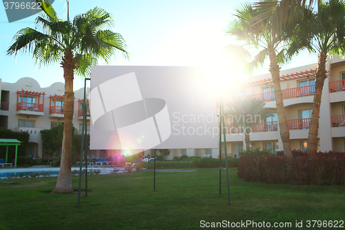 Image of Sun flare behind a blank urban billboard