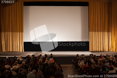 Image of Audience in front of white cinema screen