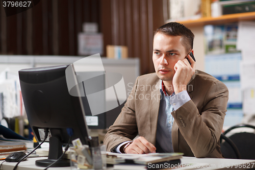 Image of Businessman talking on a mobile phone