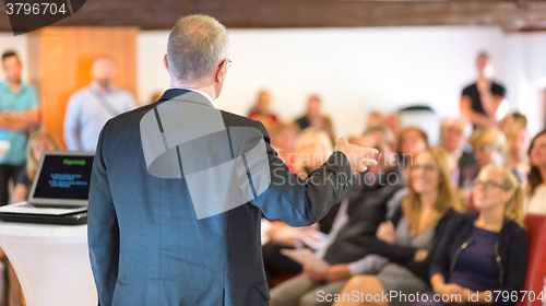 Image of Speaker at Business Conference and Presentation.