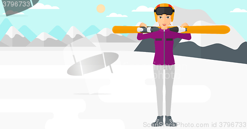 Image of Woman holding skis.