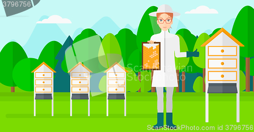 Image of Bee-keeper at apiary.