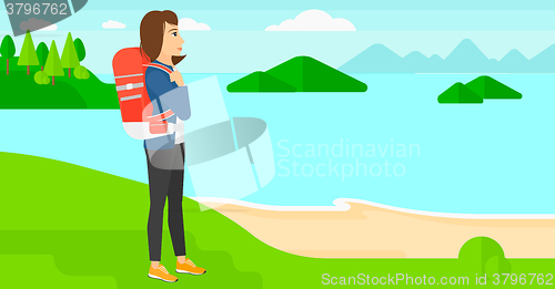 Image of Woman with backpack hiking.