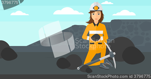 Image of Miner holding coal in hands.