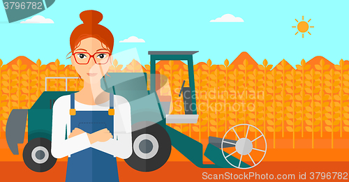 Image of Woman standing with combine on background.