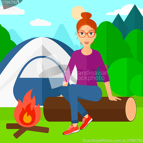Image of Woman sitting at camp.