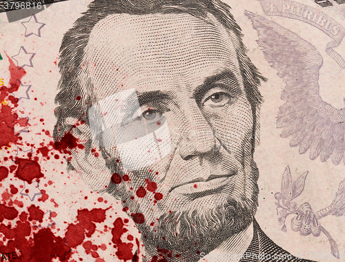 Image of US five Dollar bill, close up, blood