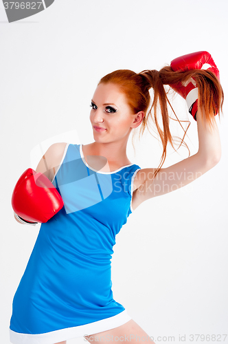 Image of Young beautiful woman in boxing gloves