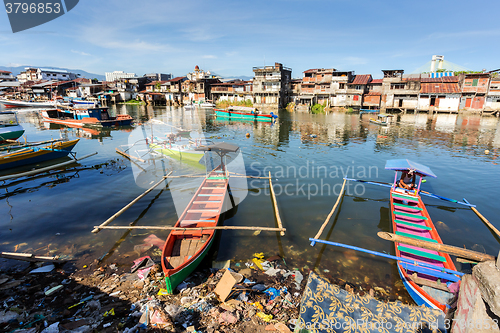 Image of poor houses by the river in shantytown