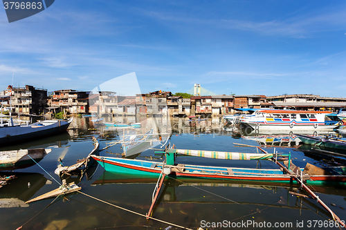 Image of poor houses by the river in shantytown