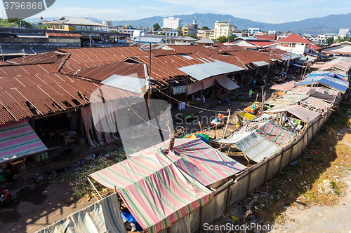 Image of poor houses by the river in shantytown