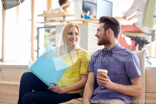 Image of office workers with folder and coffee