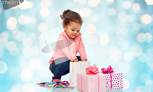 Image of happy little baby girl with birthday presents