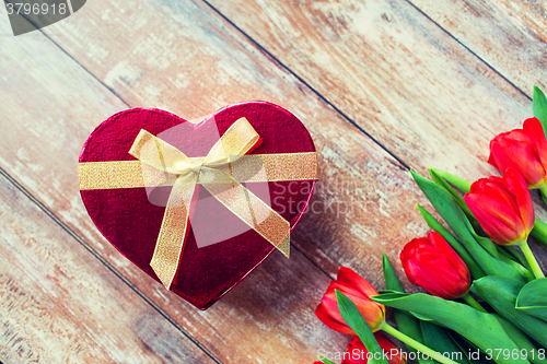 Image of close up of red tulips and chocolate box