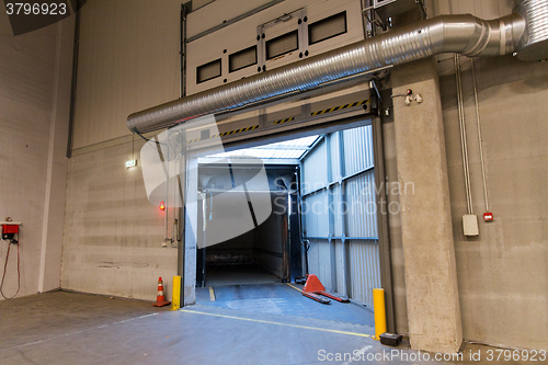 Image of warehouse door or gate and truck container