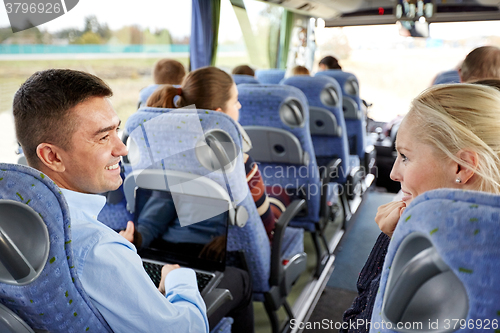 Image of group of happy passengers in travel bus