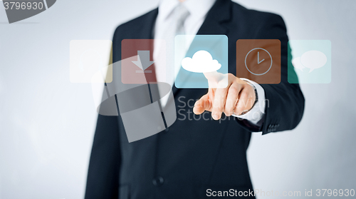 Image of close up of man pointing finger to cloud icon
