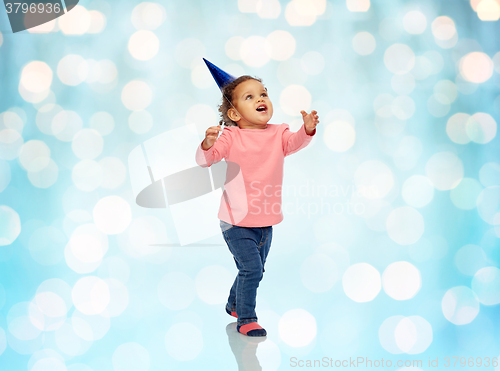 Image of happy little baby girl with birthday party hat