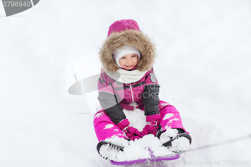 Image of happy little kid on sled outdoors in winter