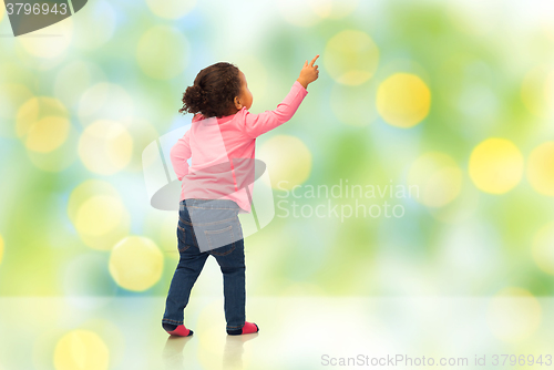 Image of african baby girl pointing finger to something