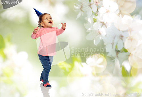 Image of happy little baby girl with birthday party hat