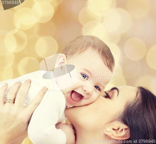 Image of laughing baby playing with mother