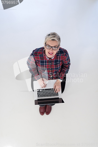 Image of top view of young business woman working on laptop computer