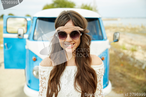 Image of smiling young hippie woman in minivan car
