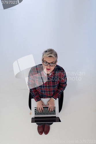 Image of top view of young business woman working on laptop computer