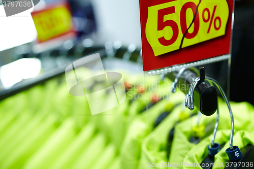 Image of Sport and casual clothes on hangers in the shop.