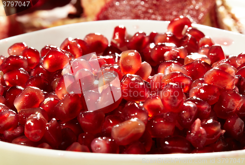 Image of Pomegranate seeds in a white bowl.