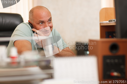 Image of Middle-aged businessman on the phone