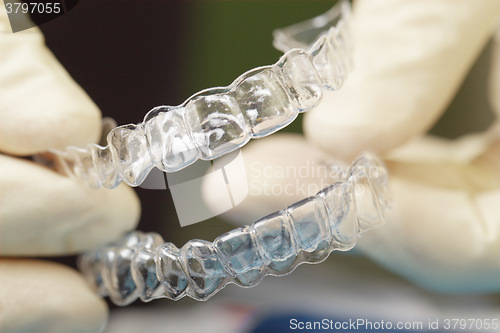 Image of Doctors hands holding silicone mouth guard