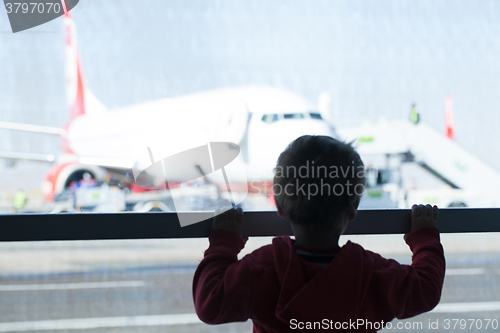 Image of Little boy watching planes at the airport