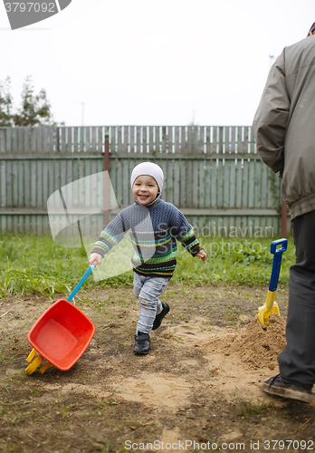 Image of Happy grandson runs with grandfather