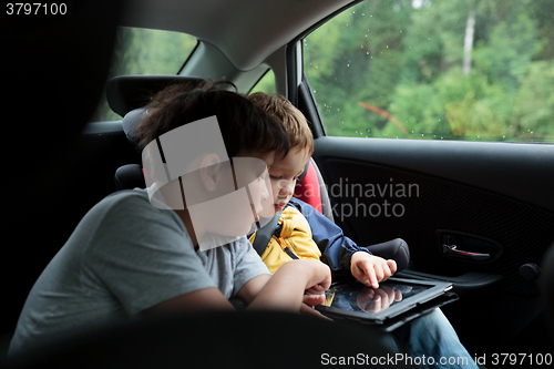 Image of Boys in the car using a touchpad