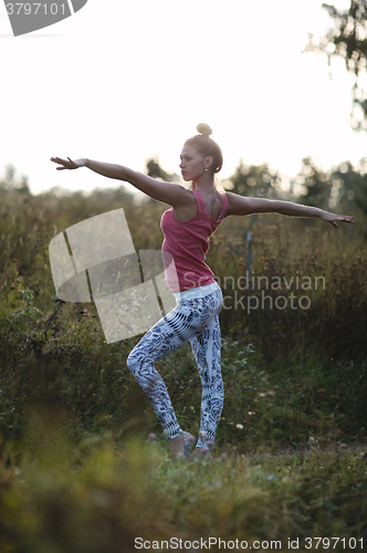 Image of Young ballerina or gymnast practising in the park