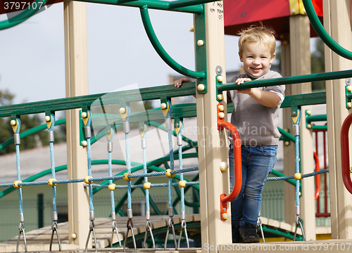 Image of Boy on playground equipment.