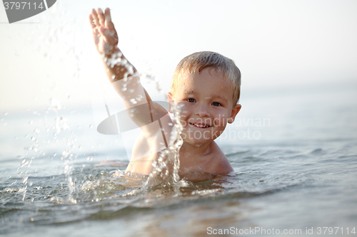 Image of Smiling little boy in the sea