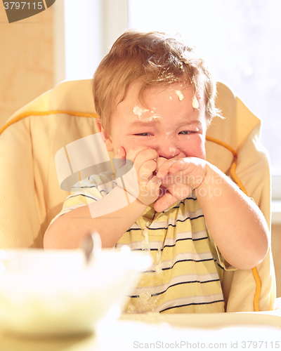 Image of Little boy doesn\'t want to eat porridge.