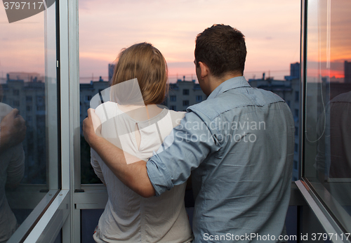 Image of Young couple on the balcony watching sunset