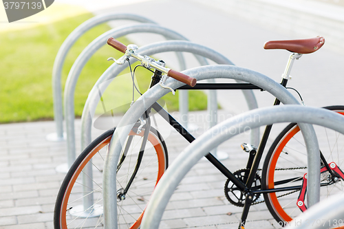 Image of close up of fixed gear bicycle at street parking