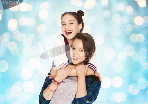 Image of happy smiling pretty teenage girls hugging